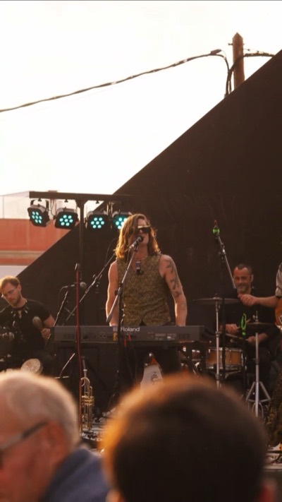 Circo Simonelli playing live on an outdoor stage at sunset